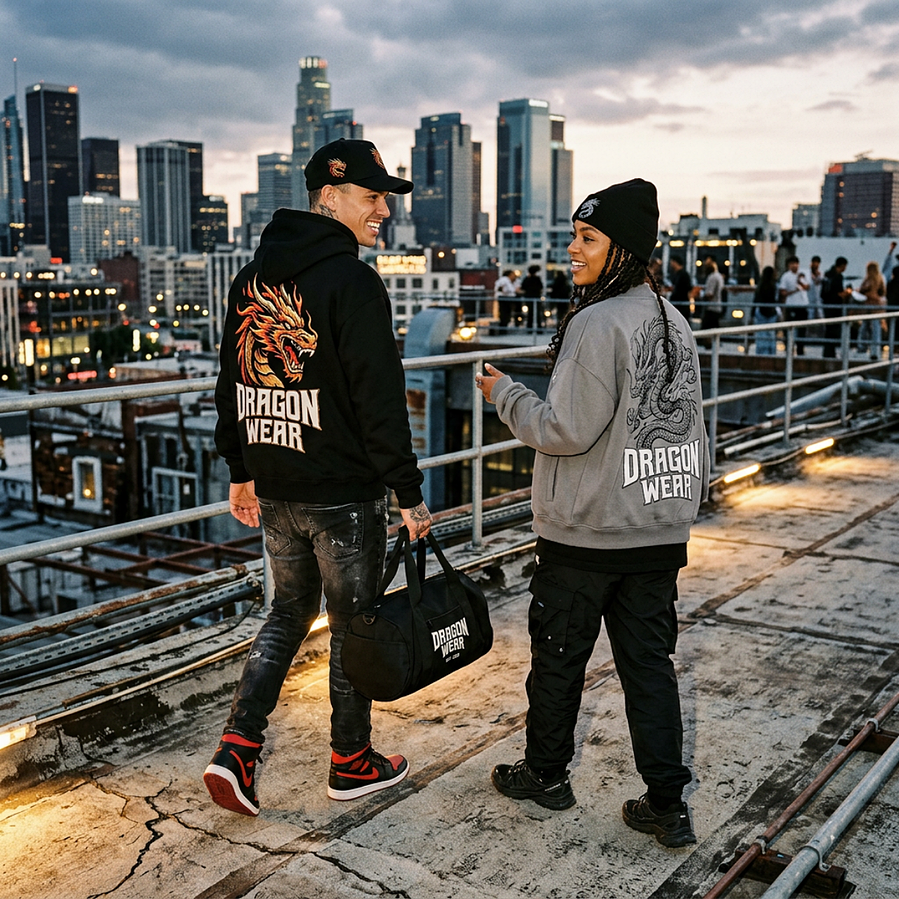 Two friends wearing Dragon Wear hoodies on a rooftop at dusk